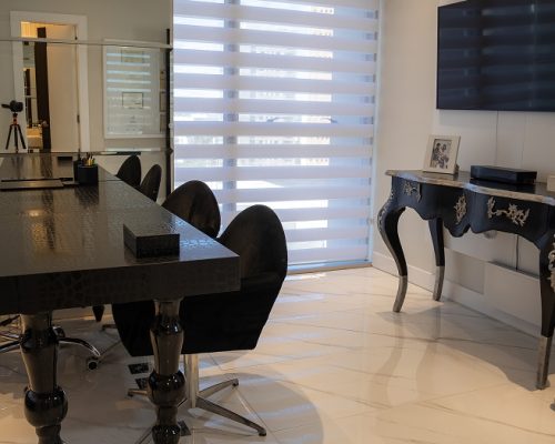 modern-spa-waiting-area-with-white-chairs-white-counter-marble-floors-natural-light-1